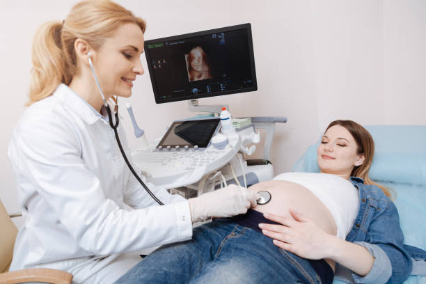 istock Lively obstetrician using stethoscope for checkup in the hospital 672837260