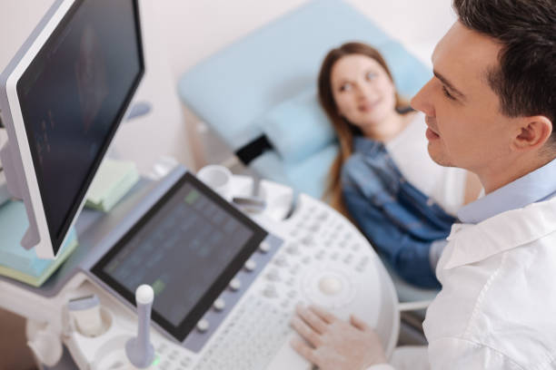 istock Handsome young practitioner providing checkup in the clinic 672841808