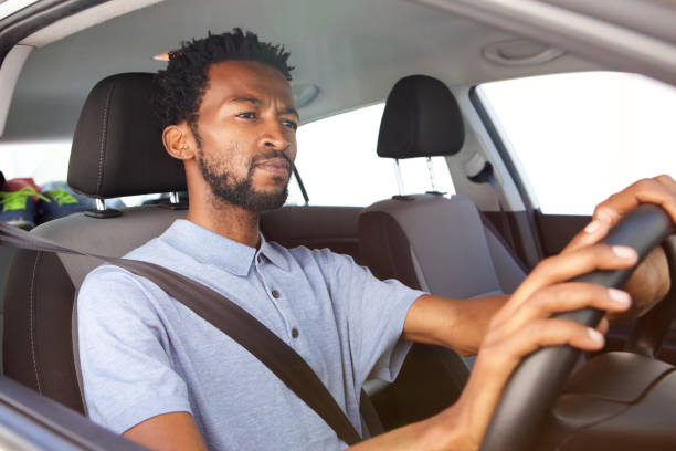 istock african american man driving car 672845916