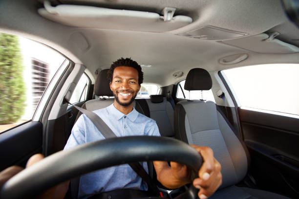 happy african american man with beard driving car Close up portrait of happy african american man with beard driving car men hairstyle afro cool stock pictures, royalty-free photos & images
