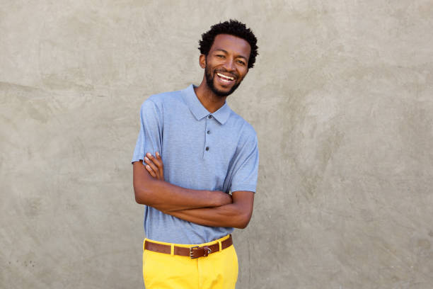 istock attractive afro american man smiling with arms crossed 672846258