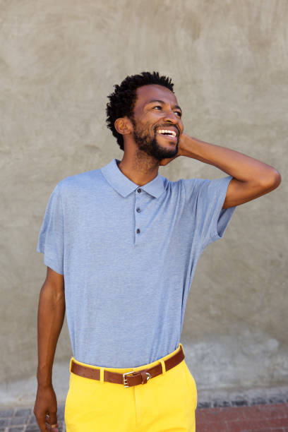 istock attractive carefree man smiling with hand to head 672846350