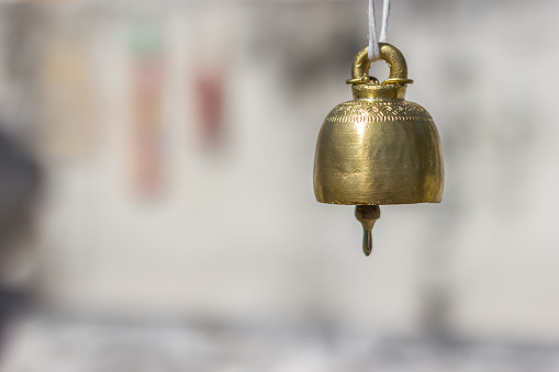Small bell used for Buddhist ceremony on blur background
