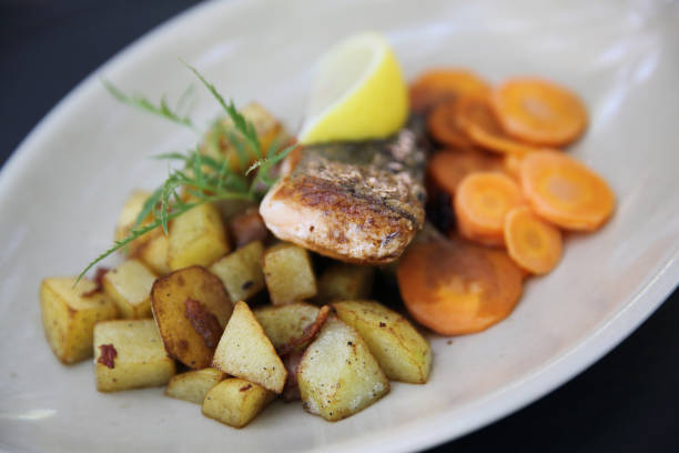 istock Baked salmon with lemon and carrot 672847646