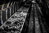Coal mine underground corridor with railway carriages and hard coal