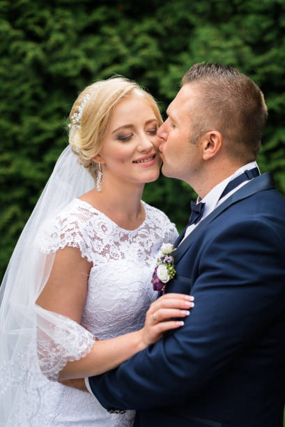 istock Bride and groom in the park 672861328