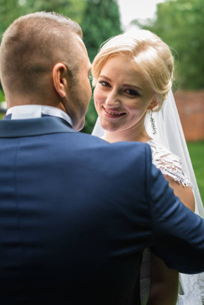 istock Bride and groom in the park 672861534