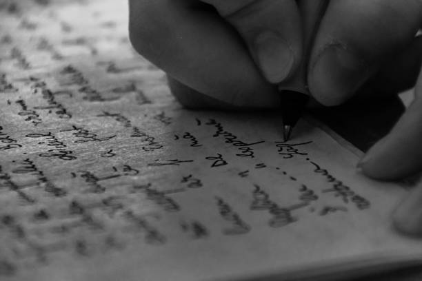 Close-Up Of Hand Writing On Paper A close-up shot of a hand writing on paper. ballpoint pen photos stock pictures, royalty-free photos & images
