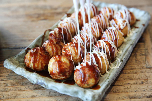 istock Takoyaki on wood background 672861754