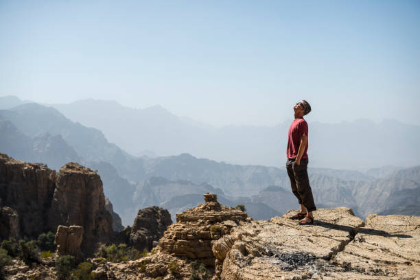 istock Man looking into sky in mountains of Oman 672862300