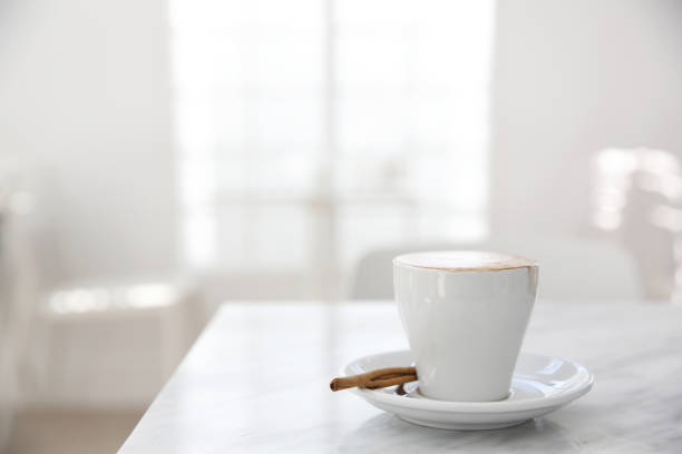 istock cappuccino coffee on wood background 672862970