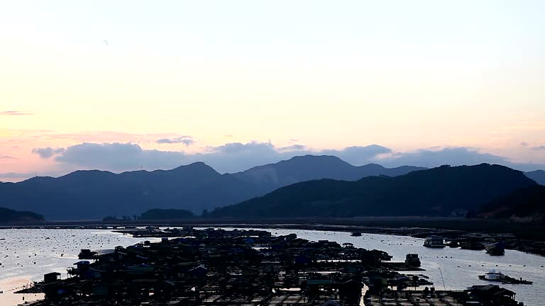 Farmers culture abalone on the sea shore, with lots of cages in the water in Xiapu, Fujian Province, They living on top of the sea.