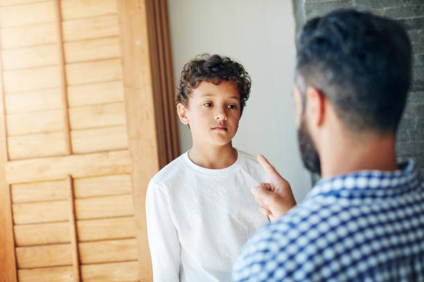 I warned you before Cropped shot of a father disciplining his little son at home punishment photos stock pictures, royalty-free photos & images