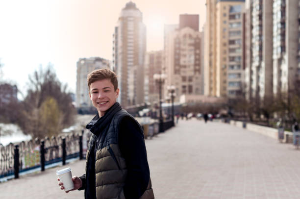 istock Happy young man on a city street 672880676