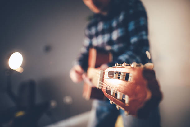 Detail of a woman's hand playing an electric guitar.