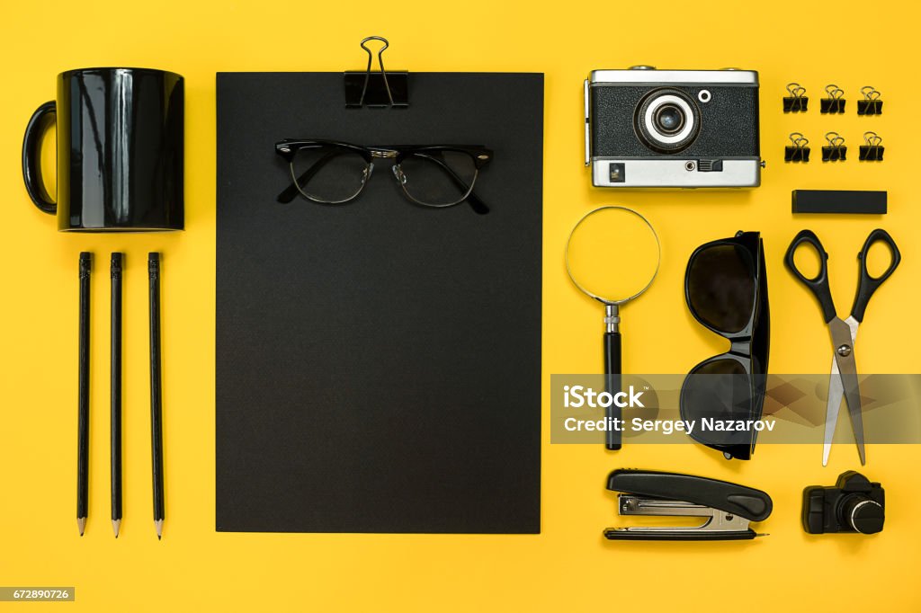 Workplace with office items and business elements on a desk. Con Workplace with office items and business elements on a yellow background. Concept for branding. Top view. Copy space. Still life Beer Glass Stock Photo