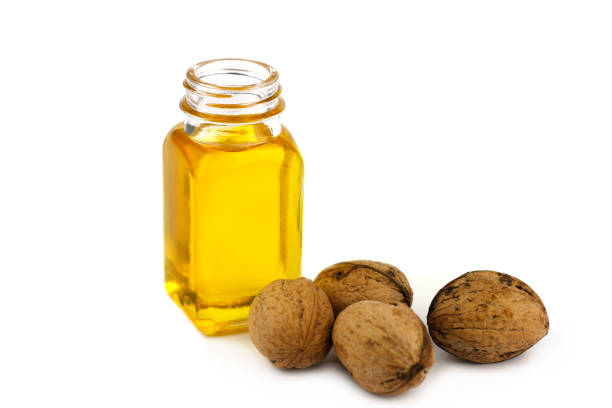 istock Walnut oil and nuts isolated on white background 672901398