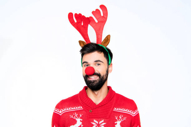 istock Smiling man in antlers and red nose 672905862