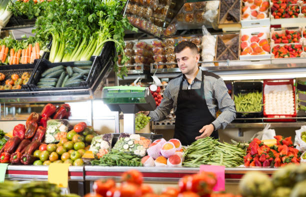 istock Guy seller is weighing grapes 672908832