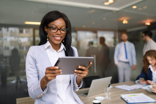 istock Young businesswoman using digital tablet in the office 672909962