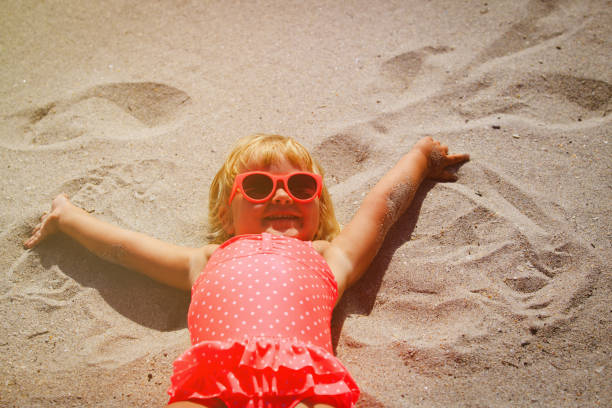 istock cute little girl play on summer beach 672910050