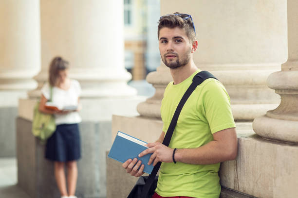 istock Schoolboy with a textbook in hand 672910346