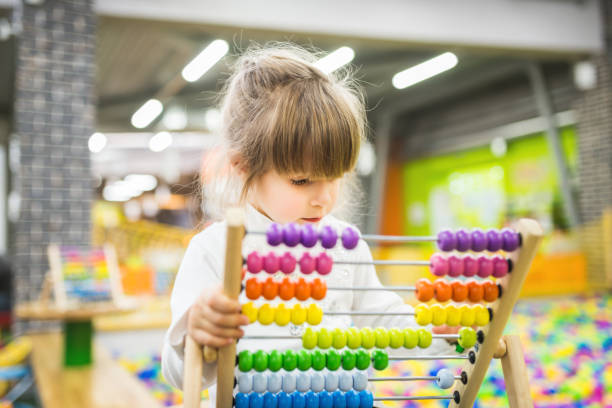 istock Little girl playing with abacus 672914590