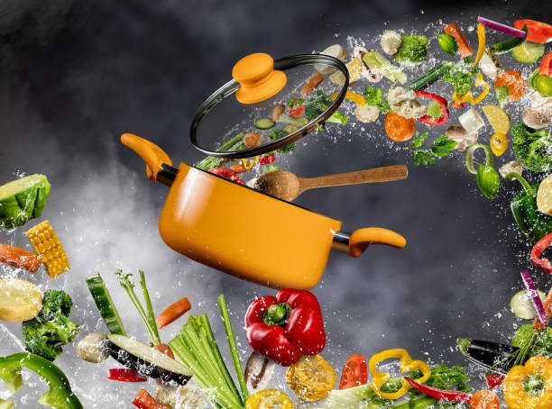 istock Fresh vegetable flying into a pot on dark background 672916326