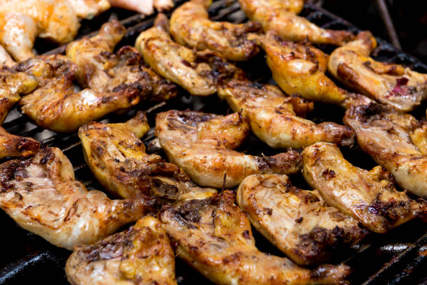 istock Chicken Quarters Cooking on a Grill 672916740