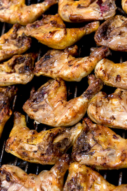 istock Broiled Chicken Quarters on a Barbecue Grill 672916748