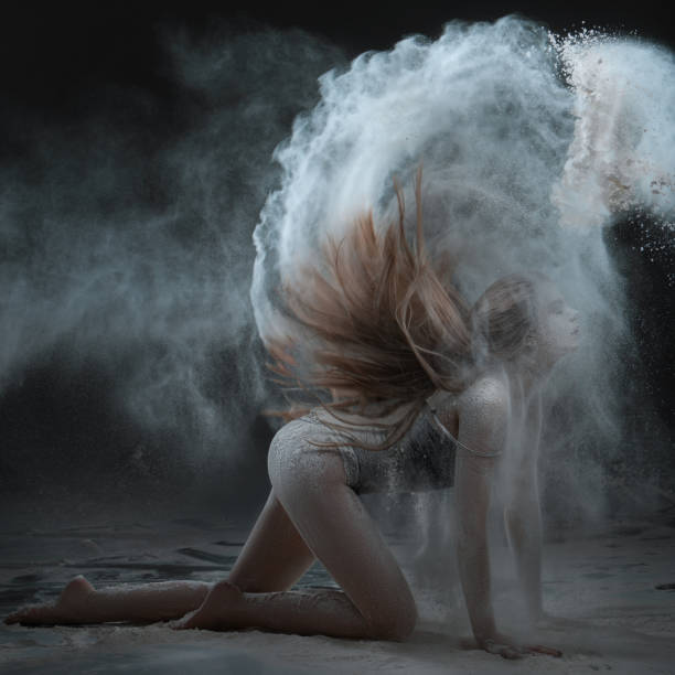 istock Woman shows a performance with flour. 672920120
