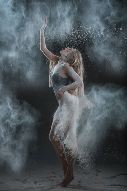 istock Woman dances in dust from flour. 672920122