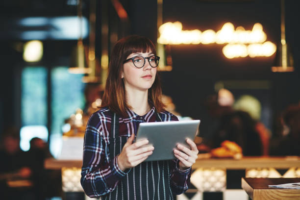 istock Keeping her cafe's social media account fresh with daily updates 672924596