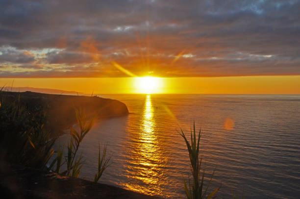 Fabulous sunset with a magic sun, observed in the Azores, with views of the ocean and the sky