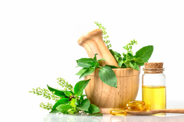 istock basil in wooden mortar with essential oil 672930474