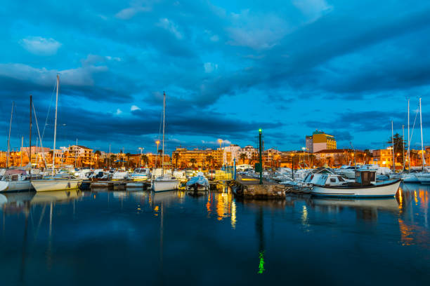 istock Boats in Alghero harbor at night 672930670