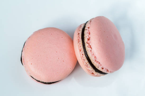 istock Two french desert pink macaron cakes top view 672930702