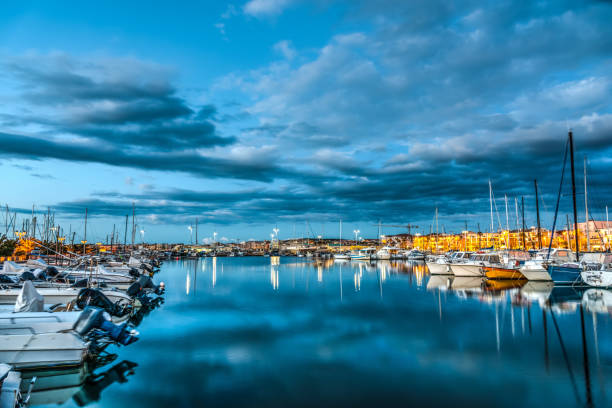 istock Boats in Alghero harbor at night 672932806