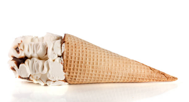 istock Ice cream cone with caramel isolated on white background 672940190
