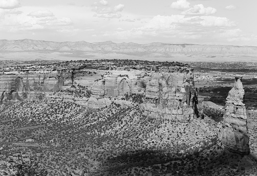 The rock formation Independence Monument and Monument Canyon as part of the Colorado National Monument. In the back the Book Cliffs. The picture is in monochrome.