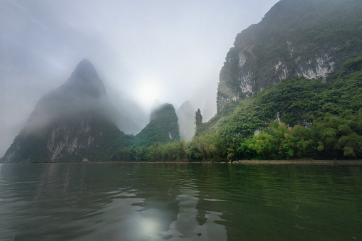 the boat is a common kind of transportation on Li River. River and Karst Mountain landscapes in Guilin is named the best in China. Dramatic sunrise This image is GPS tagged