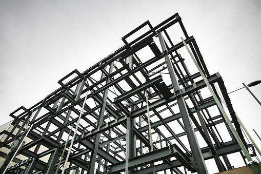 Shot of steel frame made of rsjs on a construction site in cloudy weather