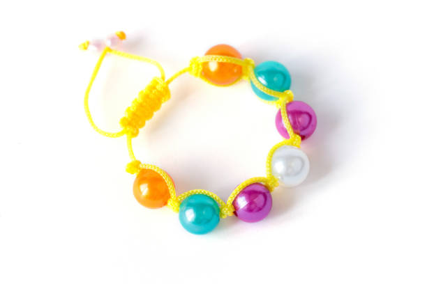 istock Colorful child bracelet isolated on white background 672944484