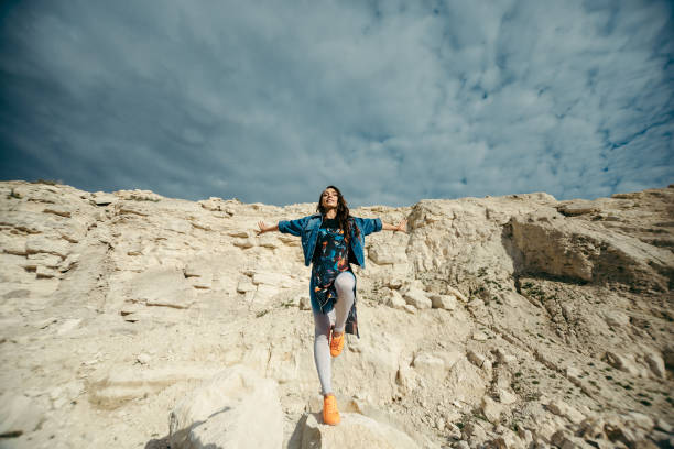 istock Young woman dressed colorful clothes posing and dancing 672951264
