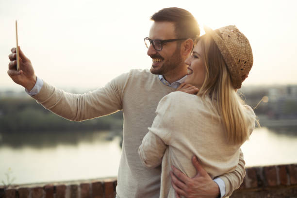 istock Tourist couple in love taking selfies while traveling 672951650