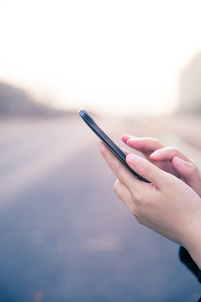 istock woman hand holding mobile phone 672957398