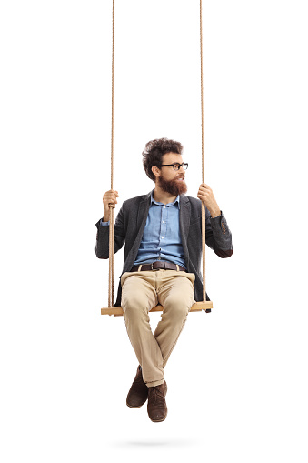 Man sitting on a swing and looking to the right isolated on white background