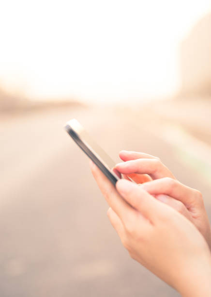 istock woman hand holding mobile phone 672957534