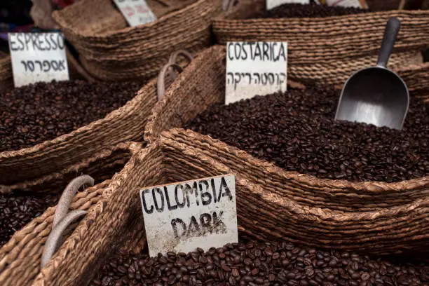 Close up on different types of roasted coffee beans: Colombian dark, Costa Rica coffee. Coffee beans for Espresso. Old city market, Acco.