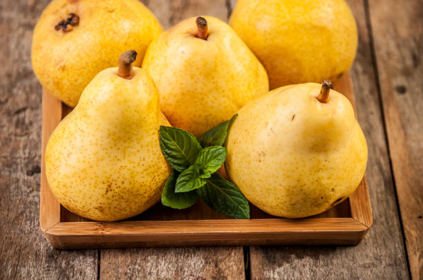 istock Fruit background. Fresh organic pears on old wood. Pear autumn harvest 672968084